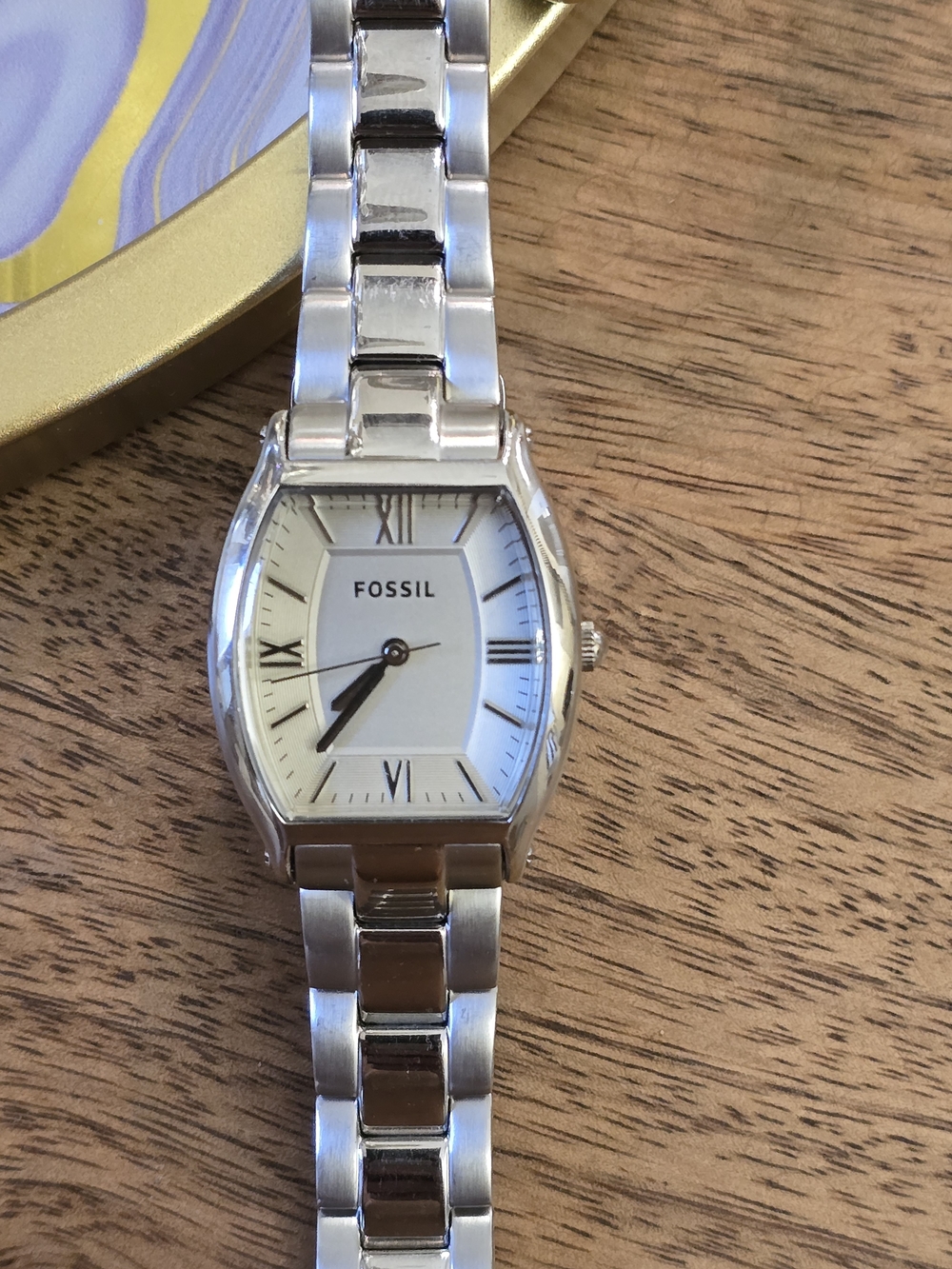 Fossil wristwatch on table